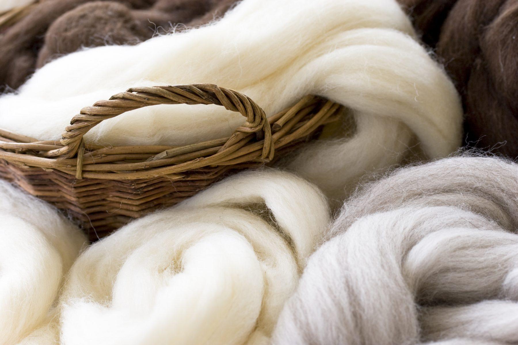 Natural wool fibres in basket, shallow DOF.